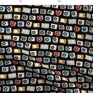 May include: A black background with a repeating pattern of colourful vintage record players. The record players are in various colours, including red, blue, yellow, and white.