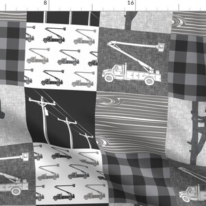 May include: A black and white patchwork fabric design featuring a repeated pattern of a utility truck with a bucket lift, a lineman climbing a pole, and power lines. The fabric also includes a black and white plaid pattern.