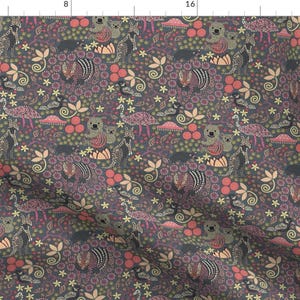 May include: A dark gray fabric with a repeating pattern of stylized animals, flowers, and leaves. The pattern includes pink, red, yellow, and green colors.