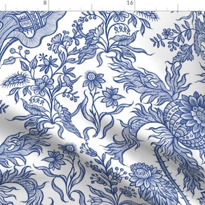May include: A white fabric with a blue floral pattern. The pattern features intricate details of leaves, flowers, and stems. The design is reminiscent of traditional blue and white china.