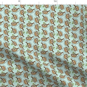 May include: A light blue fabric with a repeating pattern of brown sloths hanging from branches. The sloths are surrounded by green leaves and the text "What's the point of rushing?" is written in a circle around each sloth.