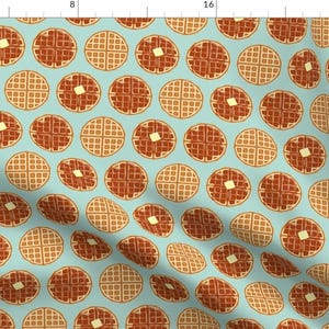May include: A seamless pattern featuring alternating brown and beige waffle illustrations on a light blue background. The waffles are arranged in a repeating grid pattern.