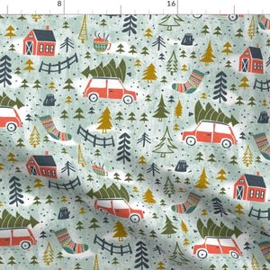 May include: A seamless pattern featuring a whimsical winter scene with red cars carrying Christmas trees, houses, and other festive details on a light blue background.