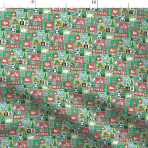 May include: A repeating pattern of green, red, and white squares with various Christmas-themed illustrations, including penguins, snowmen, trees, and presents. The text "MOMONO" and "JOY" are repeated throughout the pattern.