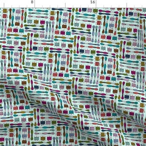 May include: A repeating pattern of colorful embroidery floss spools and needles on a light blue background. The floss spools are in various colors, including red, pink, purple, blue, green, yellow, and brown.