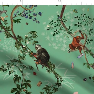 May include: A green fabric with a repeating pattern of monkeys, butterflies, and flowers. The monkeys are in various poses, some are sitting on branches, others are swinging from vines. The butterflies are flying around the monkeys and flowers. The flowers are white and have a delicate design.