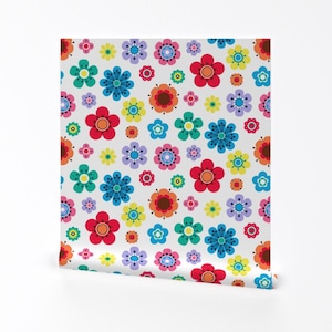 May include: A white background with a repeating pattern of colorful flowers. The flowers are in various shades of red, orange, yellow, green, blue, and purple.