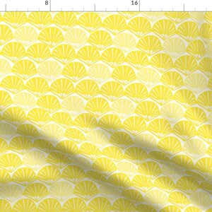 May include: A yellow and white fabric with a repeating pattern of stylized fans. The fabric has a subtle sheen and a soft texture.