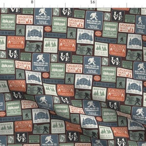 May include: A repeating pattern of vintage-style signs with illustrations of Bigfoot and Sasquatch. The signs feature text such as "Believe in Yourself!" and "Sasquatch Trail". The background is a dark brown colour.