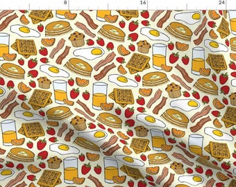 May include: A seamless pattern featuring a variety of breakfast foods, including waffles, pancakes, bacon, eggs, orange slices, and strawberries. The pattern is set on a light yellow background.