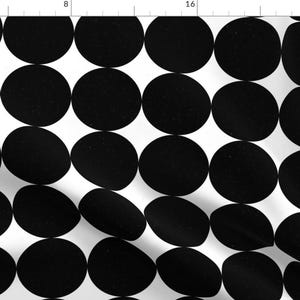 May include: Black and white polka dot pattern fabric. The fabric features large, overlapping circles in a repeating pattern.