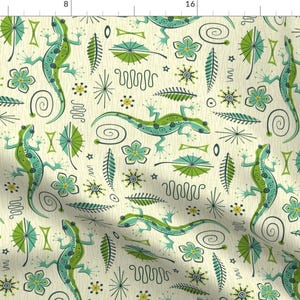 May include: A seamless pattern featuring green and blue lizards, stylized flowers, and abstract shapes on a cream background.