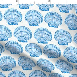 May include: A white background with a repeating pattern of blue seashells. The seashells are stylized and have a watercolor effect.