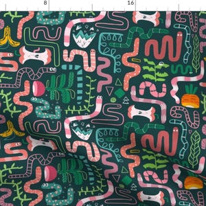 May include: A teal blue fabric with a repeating pattern of pink, green, and orange worms, bananas, carrots, and apples. The worms are in various shapes and sizes, and some have eyes. The background is a dark teal blue.