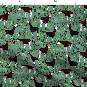 May include: A teal fabric with a repeating pattern of brown and white okapi animals surrounded by green and yellow foliage.