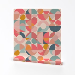 May include: A geometric pattern wallpaper with a cream background and a repeating pattern of circles, semi-circles, and squares in shades of pink, blue, and yellow.