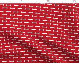 Può includere: Tessuto rosso con un motivo ripetuto di forme di ossa bianche.