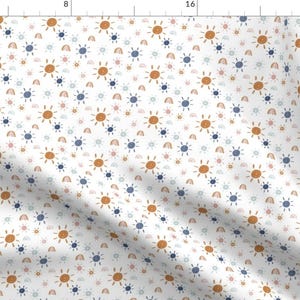 May include: A white fabric with a repeating pattern of orange suns, blue rainbows, and small pink and blue dots.