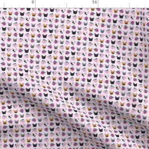 May include: A pink fabric with a repeating pattern of French bulldog faces surrounded by pink, purple, and blue flowers.