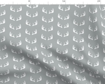 May include: A seamless pattern featuring white antlers on a gray background. The antlers are arranged in a repeating pattern, creating a subtle and elegant design.