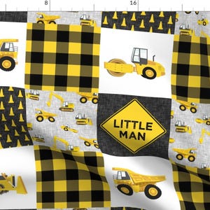 May include: A yellow and black fabric with a patchwork design featuring various construction vehicles, including dump trucks, excavators, and a road roller. The fabric also includes a black and yellow checkered pattern and a yellow sign that reads "Little Man".