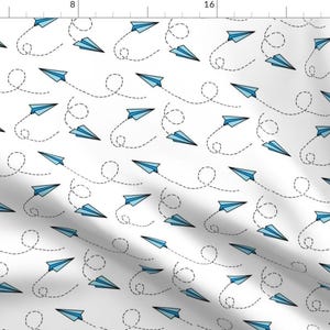 May include: A white background with a repeating pattern of blue paper aeroplanes with dashed lines representing their flight paths.