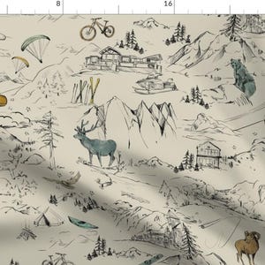 May include: A cream-colored fabric with a hand-drawn mountain scene. The design includes mountains, cabins, animals, and recreational equipment like skis, bikes, and paragliders. The artwork is in black and white with watercolor accents.