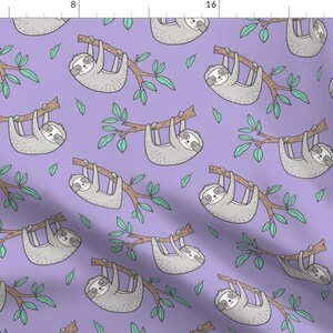May include: A repeating pattern of cartoon sloths hanging from brown branches with green leaves on a lavender background. The sloths are gray with white faces and black eyes. The design is suitable for fabric or wallpaper.