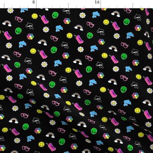 May include: Black fabric with a repeating pattern of colorful 90s-themed icons. The design includes smiley faces, alien heads, dolphins, rainbows, sunglasses, flowers, and pink cell phones.