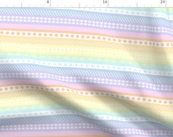 May include: A colourful fabric with a rainbow stripe pattern. The stripes are decorated with different patterns, including dots, stars, and lines. The fabric is a light and airy material, perfect for crafting or sewing projects.