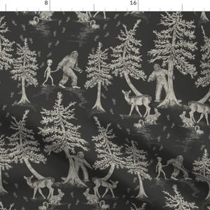 May include: A black and white patterned fabric featuring a repeating design of trees, deer, Bigfoot, and aliens. The design is reminiscent of a traditional toile pattern.