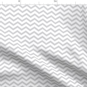 May include: A white fabric with a gray chevron pattern. The fabric is folded and has a slight wrinkle.