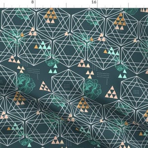 May include: Teal blue background with a geometric pattern of white lines forming overlapping hexagons and triangles. The pattern is accented with small pink and gold triangles. There are also stylized floral designs in a light green color.
