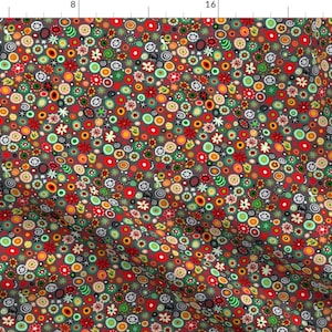 May include: A seamless pattern featuring a variety of colorful abstract flowers and circles on a dark gray background.