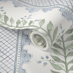 May include: A roll of wallpaper with a watercolour design. The design features a light blue and green floral border, a trellis pattern, and botanical elements. The colour palette is soft and muted, with a focus on blues, greens, and white.