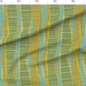 May include: A fabric with a striped pattern in shades of green, yellow, and blue. The fabric has a textured, woven look.
