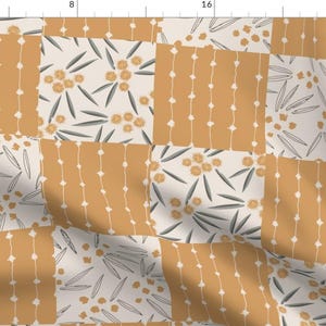 May include: A patchwork fabric design featuring alternating squares of mustard yellow and off-white. The yellow squares have vertical rows of white dots. The off-white squares have floral and leaf patterns in gray and yellow. This fabric is suitable for quilting and crafting.