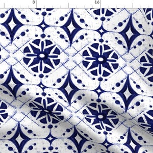 May include: A seamless pattern featuring a repeating design of blue and white geometric shapes. The pattern is reminiscent of traditional tile designs.