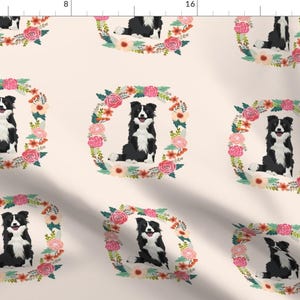 May include: A seamless pattern featuring black and white border collies sitting inside floral wreaths. The wreaths are made of pink, red, and green flowers. The background is a light beige color.