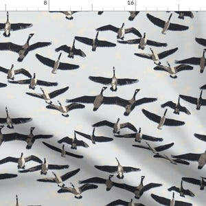May include: A seamless pattern featuring a repeating design of geese flying in formation against a light blue background. The geese are depicted in shades of brown and gray, with their wings spread out.