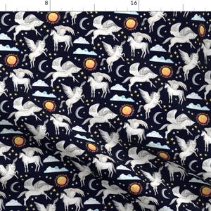 May include: A seamless pattern featuring white winged unicorns on a dark blue background. The pattern also includes yellow suns, white moons, and white clouds.