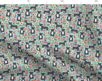 May include: A seamless pattern featuring black and white pit bull dogs with floral accents on a turquoise background.