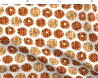 May include: A repeating pattern of round waffles with square butter pats on a white background. The waffles are a mix of light and dark brown, with a grid pattern. The butter is yellow. This design is suitable for fabric or wallpaper.