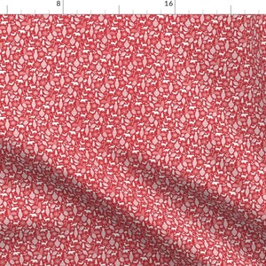 May include: Red fabric with a white repeating pattern of Christmas ornaments, trees, stars, and other holiday symbols.