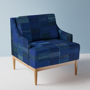 May include: A blue armchair with a patchwork design and wooden legs.