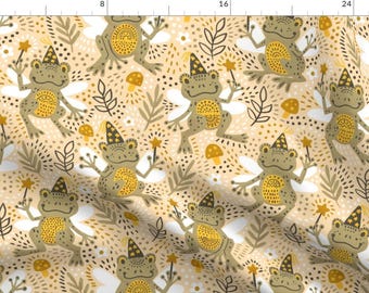 May include: A seamless pattern featuring whimsical green frogs wearing yellow wizard hats and holding magic wands. The frogs have white wings and are surrounded by yellow mushrooms, brown leaves, and white flowers on a beige background.