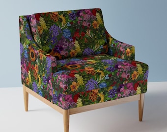 May include: A floral armchair with a vibrant floral print featuring a variety of flowers in shades of red, yellow, blue, and purple. The chair has a wooden frame with light brown legs.