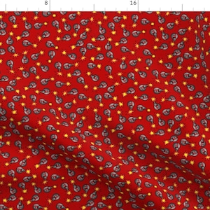 May include: A red fabric with a repeating pattern of a gray and yellow cartoon image. The cartoon image is a small, round object with a yellow star on top. The fabric is suitable for crafting projects.