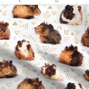 May include: A white background with a repeating pattern of brown and white guinea pigs and gold geometric shapes. The guinea pigs are in various poses, some are sitting, some are standing, and some are looking at the camera.