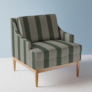 May include: An armchair upholstered in a dark green and light grey vertical striped fabric. The chair features a square backrest, integrated armrests, and a thick seat cushion, all supported by four light-toned wooden legs in a tapered design.